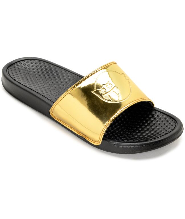 gold and black nike sandals